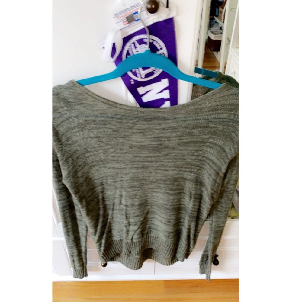 Green sweater with cross patch in back